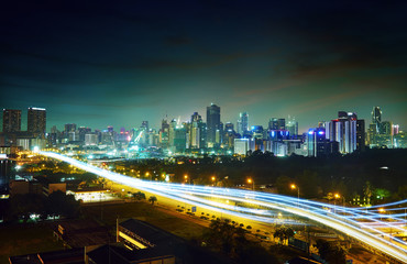 Abstract and car lighttrail  background, city skyline downtown background and highway interchanged nigh view .