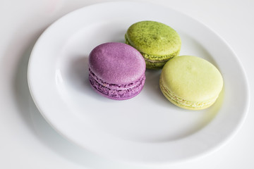 Macaroon purple and green on a plate.