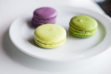 Macaroon purple and green on a plate.