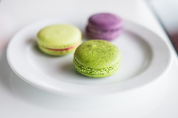 Macaroon purple and green on a plate.