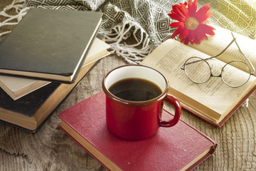 Books with reading glasses on desk