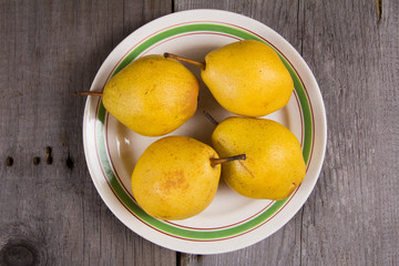 Fresh ripe organic yello pears on rustic wooden table, natural background, diet food.
