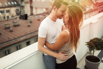 Couple hugging on rooftop terrace