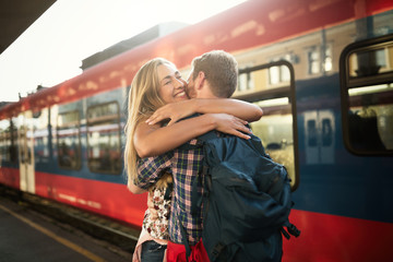 Beautiful couple hugging after long journey