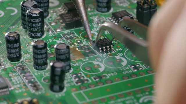 Assembling a circuit board. Soldering chip on motherboard
