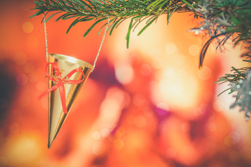Branch with a Christmas cornet hanging on a tree in the holiday season in December celebrating...