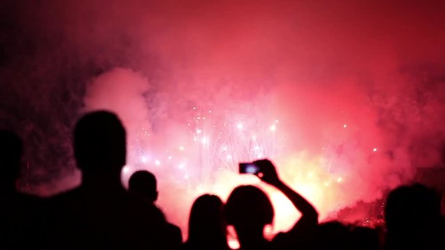 People Filming and taking pictures of Fireworks Display WITH AUDIO. Beautiful Fireworks HD. Beautiful moving particles background and glitter USA. 4th of July, New Year Celebration. Selfie