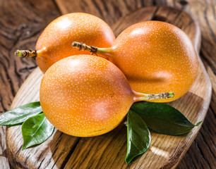 Granadilla fruits on the wooden table.