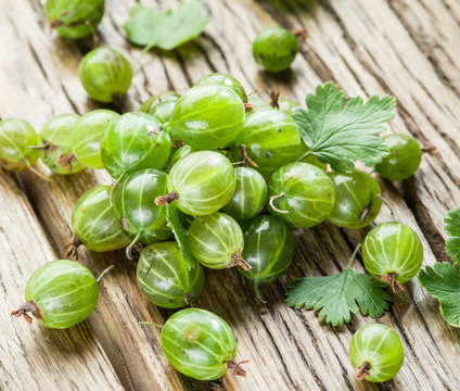 Gooseberries on the wooden table.