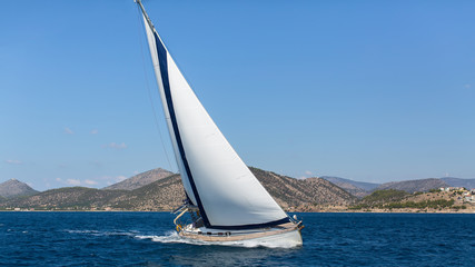 Fototapeta na wymiar Ship yachts with white sails in the open Sea. Luxury Sailing. ..