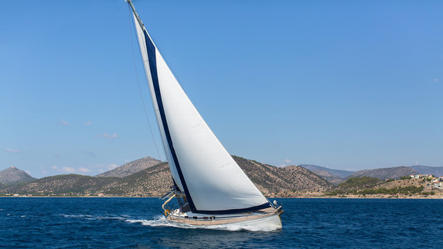 Ship yachts with white sails in the open Sea. Luxury Sailing. ..