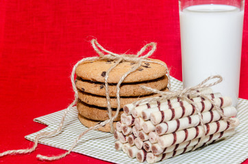 round biscuits and sweet rolls with a glass of milk