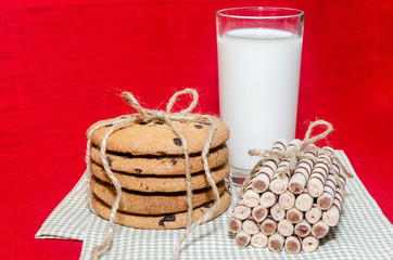 round biscuits and sweet rolls with a glass of milk