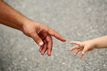 babys hand holding mothers