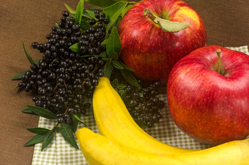 Composition with bananas, apples and dark wild berries