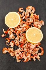 Plexiglas foto achterwand cleaned and cooked crayfish tails with lemon on slate © Szakaly