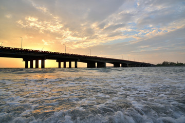 Fototapeta na wymiar sunset bridge over a sea