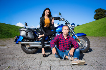 Fototapeta na wymiar young man and woman posing with vintage motorbike