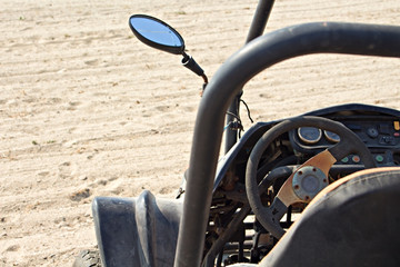 A dune buggy left abandoned on a beach
