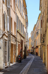 Romantic tiny street in central Aix-En-Provence, South of France on hot summer day without pedestrians