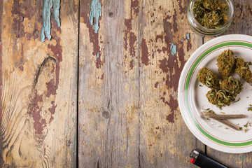Fototapeta na wymiar Marijuana buds and joints in the white plate