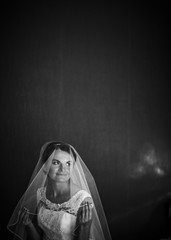 Black and white picture of radiant bride sitting in a room