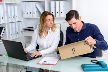 businessman and businesswoman with delivery in the office