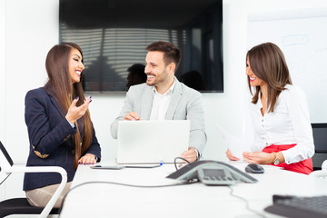 Fototapeta premium Group of happy young business people in a meeting at office