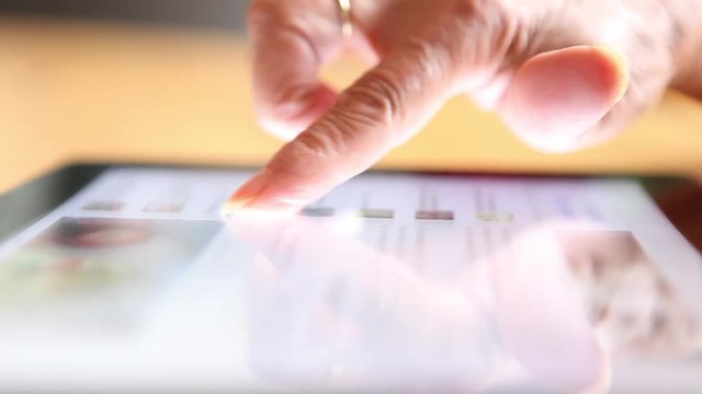 old woman using tablet ipad pc close up fingers no brand 