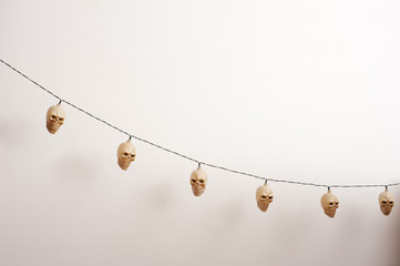 Electric lamp skulls hanging near wall