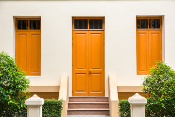 orange Door , orange window on Cream Wall on orange staircase wi