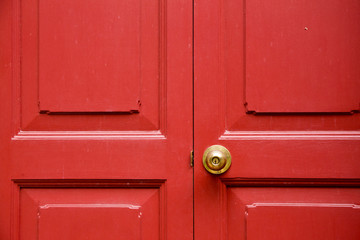 Door knob golden color with red door background