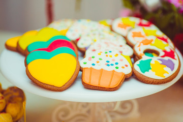 Pretty cookies in the form of hearts and cupcakes with colorful