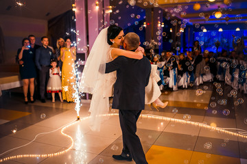 Wedding dance with  bubbles. Bride and groom whirl in restaurant. dancing couple
