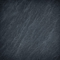 Dark grey black slate stone background or texture.