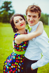 Pretty brunette woman hugs man in green bow tie