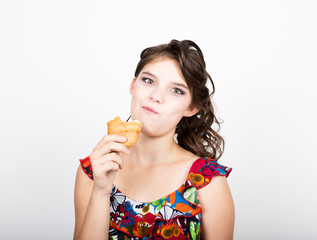 Young smile girl holding and biting bread roll