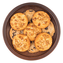 Cookies with peanuts and chocolate in a brown plate. Isolated on
