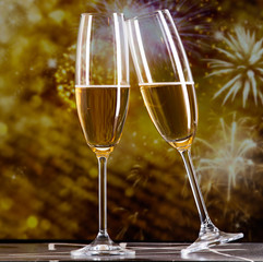 toasting with champagne glasses against holiday lights