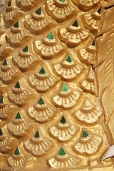 Dragon scales statue. Stucco surface background. Thai art