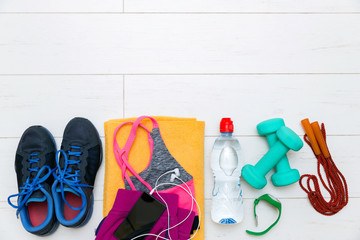 fitness equipment and accessories on white wooden gym floor