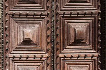 Detail of an ornate brown wooden door