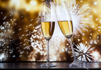 toasting with champagne glasses against holiday lights