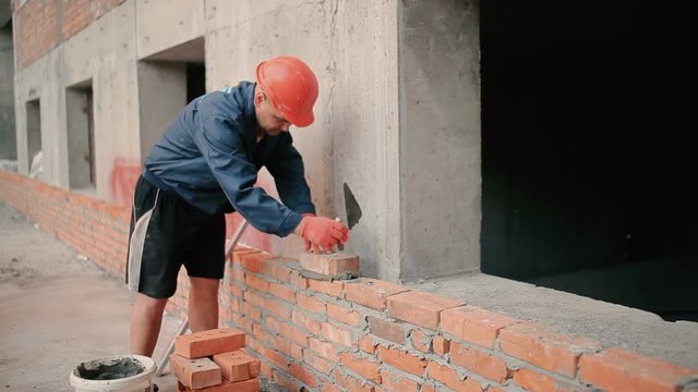 Builder puts a brick wall