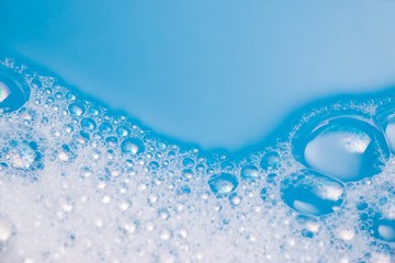 Abstract background of soap foam, suds, shower. Blue background. soft focus, macro view