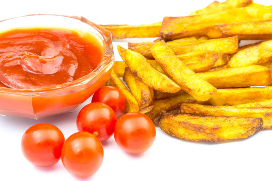 Homemade fast food, portion of french fries, ketchup and cherry tomato isolated on white background.