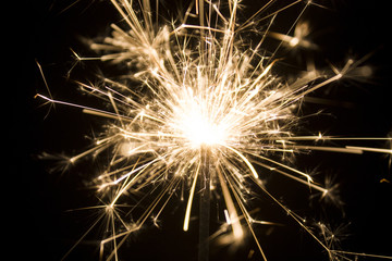 Burning sparkler isolated on black background