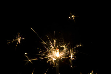 Burning sparkler isolated on black background