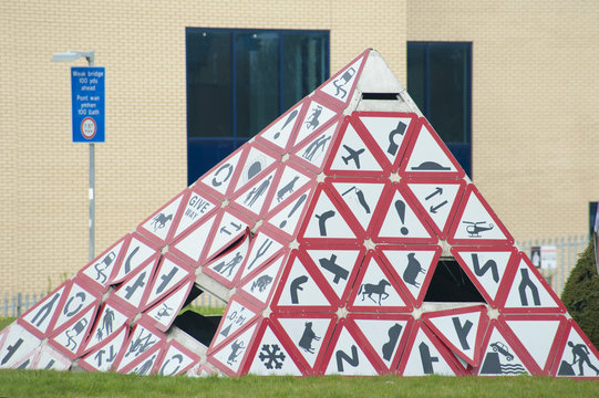 Triangular sculpture formed from road signs