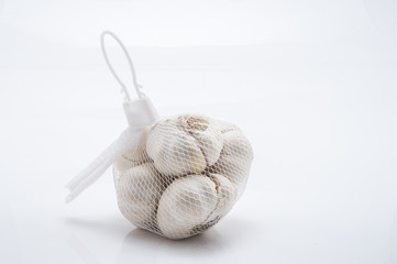 Garlic isolated  wrapped in white gauze background.